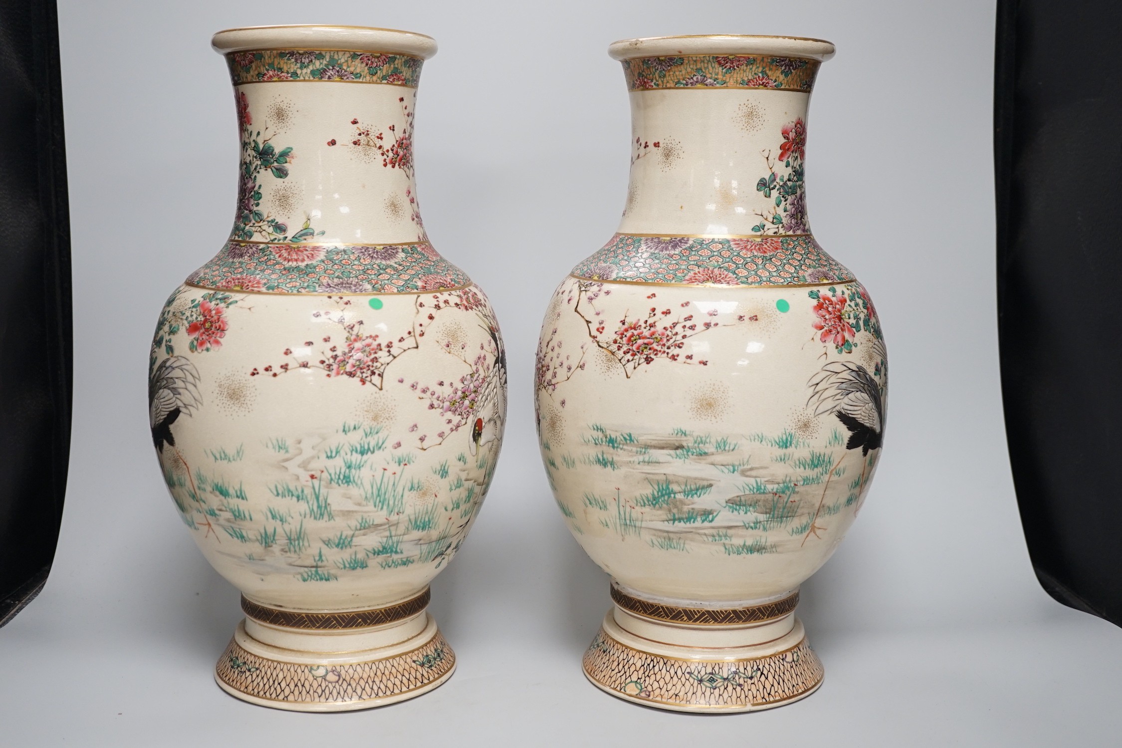 A pair of Japanese Satsuma pottery vases, Meiji period signed above foot, height 38cm